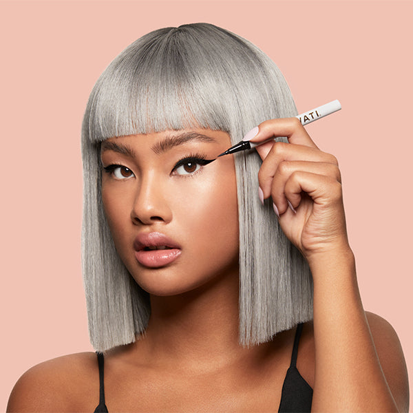 SWATI Cosmetics model applying Vanta adhesive eyeliner